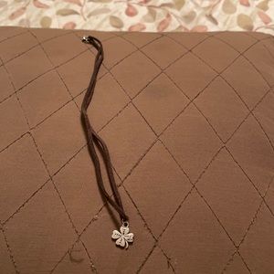 Cute sterling silver 4 leaf clover on brown chord.